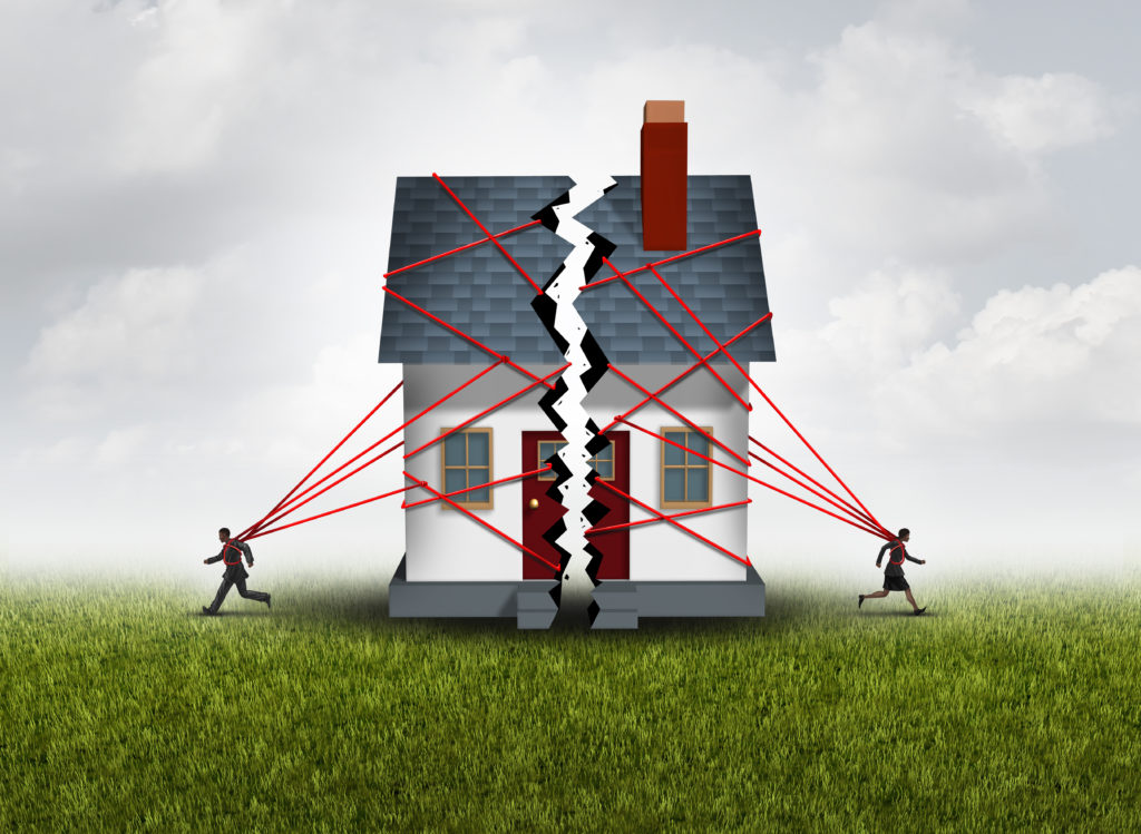 Image of two people running towards opposite sides with half a house tied with ropes behind them. Representation of Community Property and Divorce in Idaho